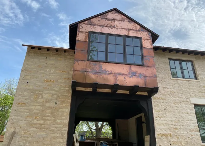 Copper metal panel facade on a stone building for Metal Roof Coating in Royalton